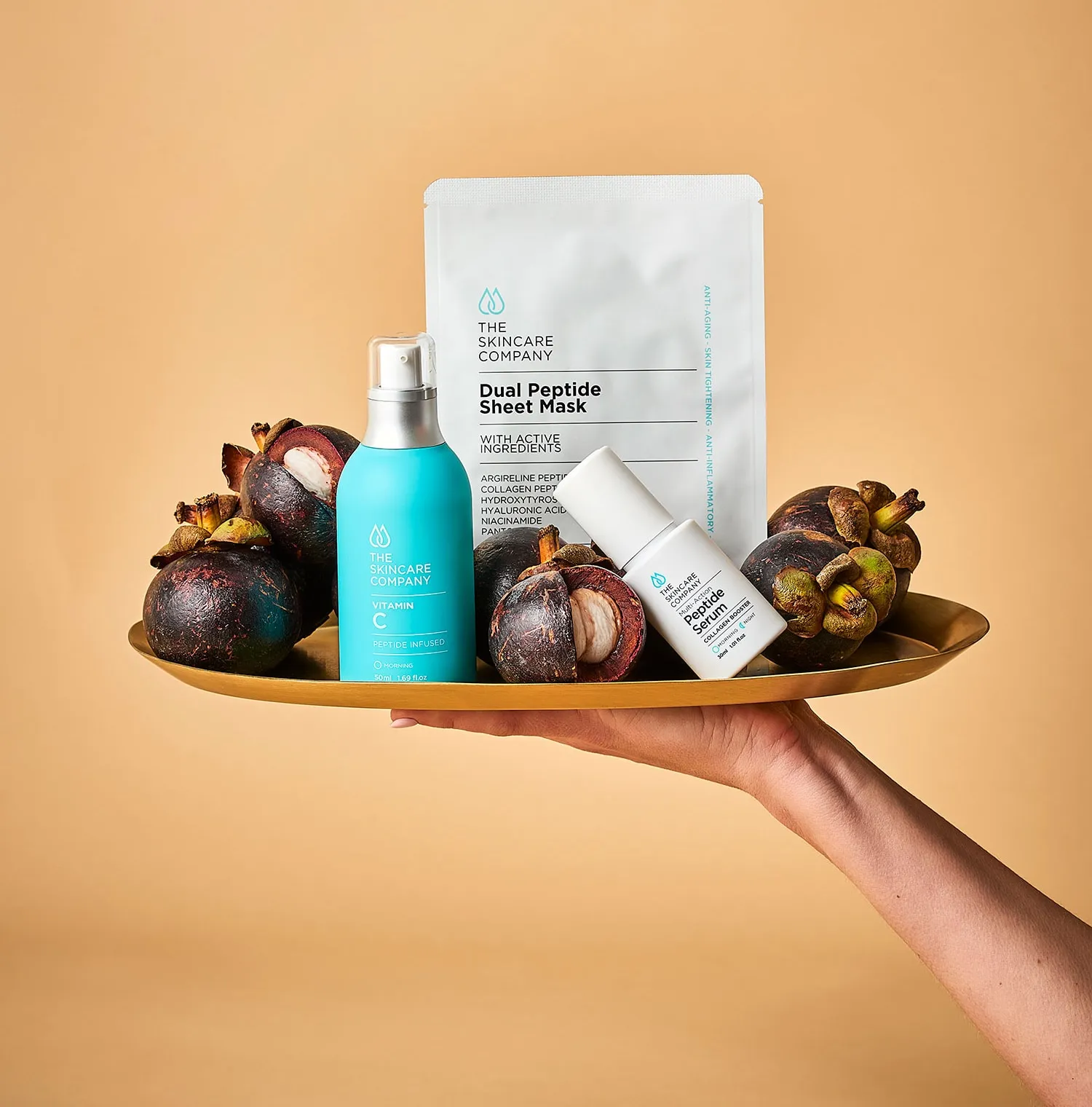 The Skincare Company professional skincare products presented on a brass tray.